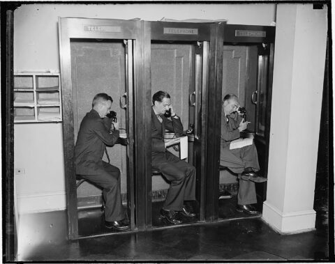Reporters using telephones in White House press room